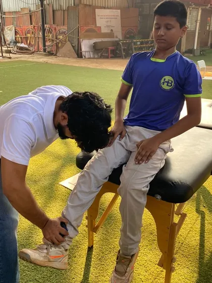 A physio works on a player's leg on a therapy table. Hands-on treatment and recovery support are integral parts of our high-performance program.