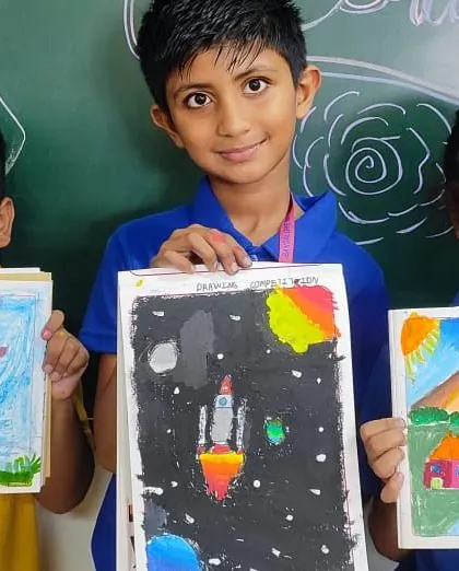 Students proudly display their colorful artwork. Our arts program encourages creativity and self-expression across all grades.