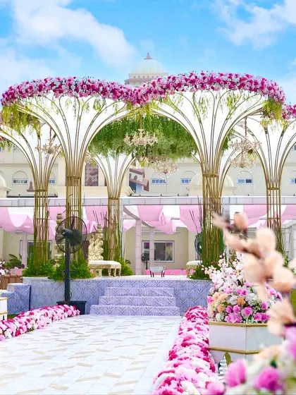 Our signature Lotus Vidhi Mandap creates a truly royal and unforgettable setting for your vows. We designed this magnificent structure to stand out against the palatial backdrop, using thousands of pink and white florals to craft an atmosphere of pure romance and grandeur.