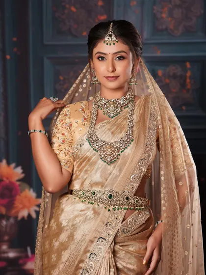 A full view of the model, showcasing the complete look with a Polki and emerald hip belt.