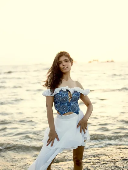 A direct-to-camera pose in the beach dress, capturing a confident and alluring look during the golden hour.