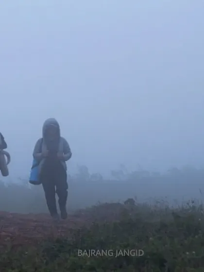 Two participants on the trail during our silent trek. The misty landscape adds to the serene and introspective atmosphere of the journey.