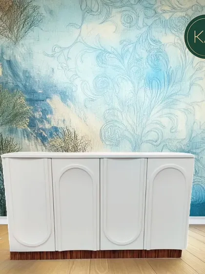 The same white cabinet photoshopped against an artistic backdrop, illustrating how its design can complement a vibrant and stylish interior.