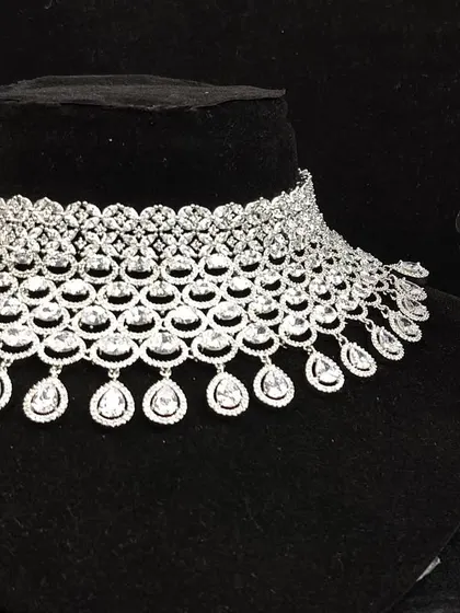 This American diamond necklace set features a delicate design with teardrop danglers, making it a graceful and elegant rental choice for any event.