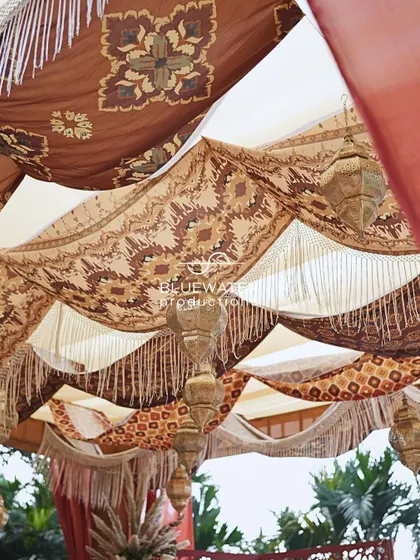 A close-up of the layered fabric ceiling at the Souk-themed Mehendi, showing the intricate patterns and hanging tassels.