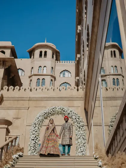 A grand portrait set against the magnificent architecture of a Jaipur palace. I use the venue's scale to create breathtaking images that feel both royal and personal.