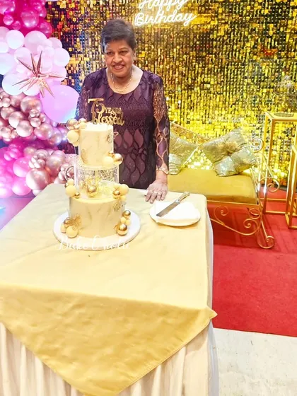 The birthday girl with her beautiful two-tier white and gold cake. It's a joy to be part of these milestone celebrations.