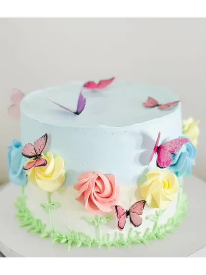 Another angle of this dreamy butterfly garden cake. The soft pastel colors and delicate edible butterflies make it a perfect centerpiece for a spring celebration or birthday.