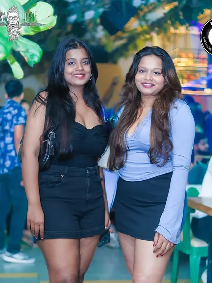 Two friends posing for a photo, enjoying the Saturday night Bollywood vibes.