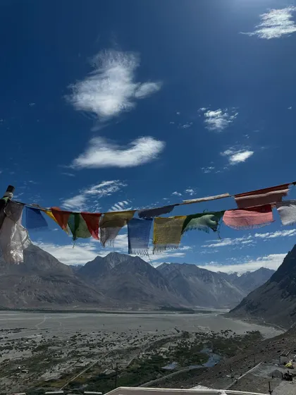 The vibrant prayer flags against the vast, dramatic sky of Ladakh. They are a constant reminder of the spiritual energy that permeates this land, a beautiful symbol of hope and compassion.