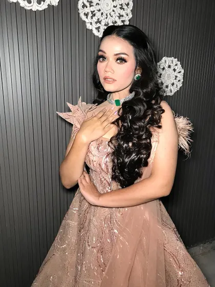 The full look, with the dramatic cape and flowing curls.