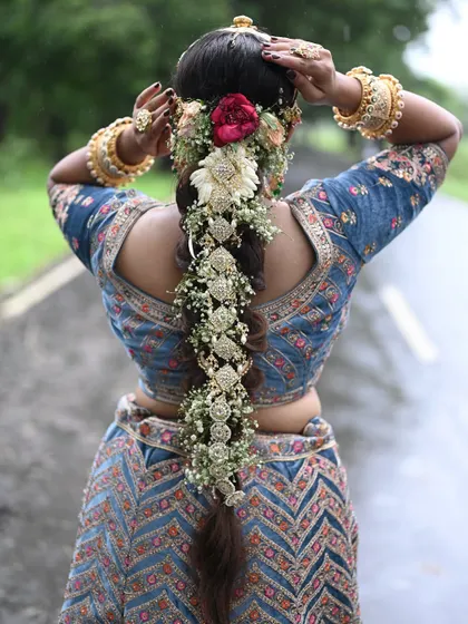 A stunning bridal braid adorned with traditional Indian hair jewelry and fresh flowers. This is a popular style for weddings and we teach it in detail.