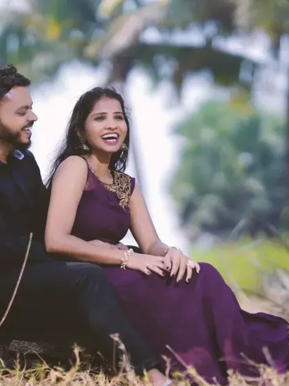 A candid moment of laughter shared under a palm tree during a relaxed outdoor shoot. These unposed moments often become the most cherished memories.