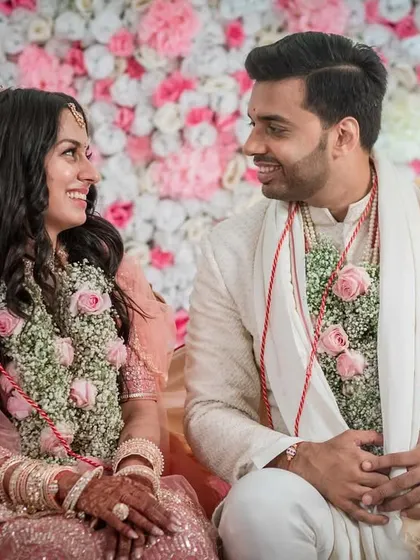The first portrait as a married couple. Seated in the mandap, they share a look of love and contentment, their journey together just beginning.