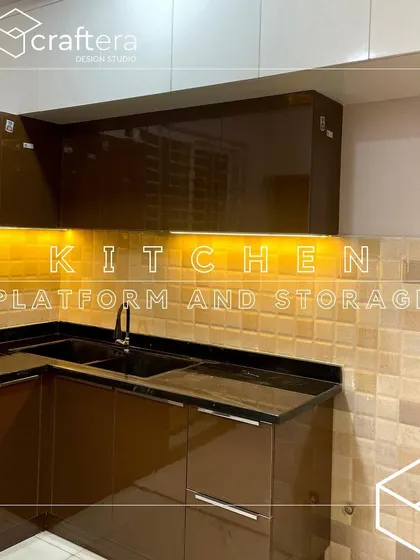 This kitchen uses a warm color palette with brown acrylic cabinets and a textured tile backsplash. The under-cabinet lighting provides excellent task lighting while highlighting the beautiful tiles.
