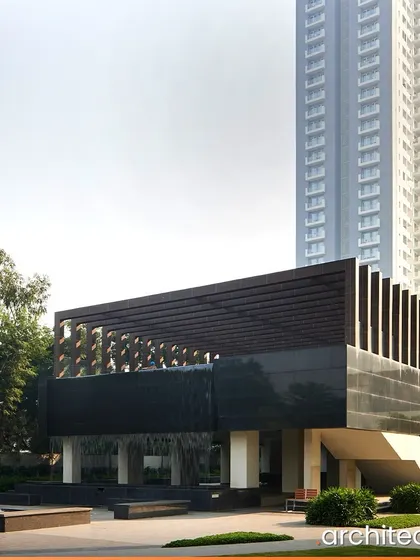 The clubhouse at EMAAR Digital Homes in Gurgaon is designed as a modern pavilion set within a lush landscape. The cascading water feature at the entrance creates a dramatic and welcoming arrival experience for residents and guests.