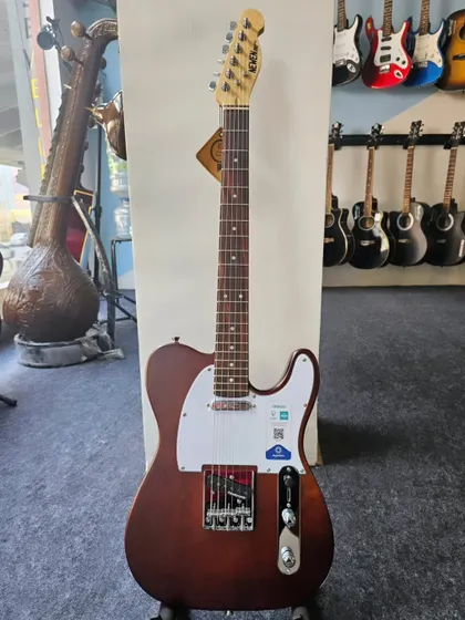 The NEWEN Telecaster style electric guitar, handcrafted in Argentina from solid Patagonian wood. This full-shot shows its natural wood finish and classic design.