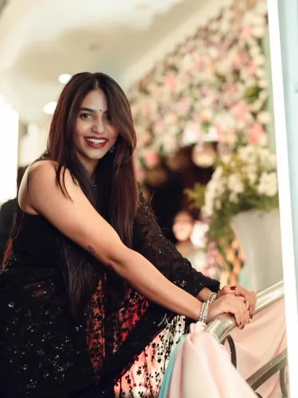 The lovely Sapthami Gowda having a desi girl moment in a sparkling black sequin saree.