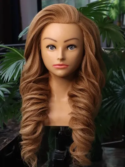 A front view of the voluminous wedding hairstyle. The soft, sweeping front frames the face beautifully, while the curls add drama and elegance.