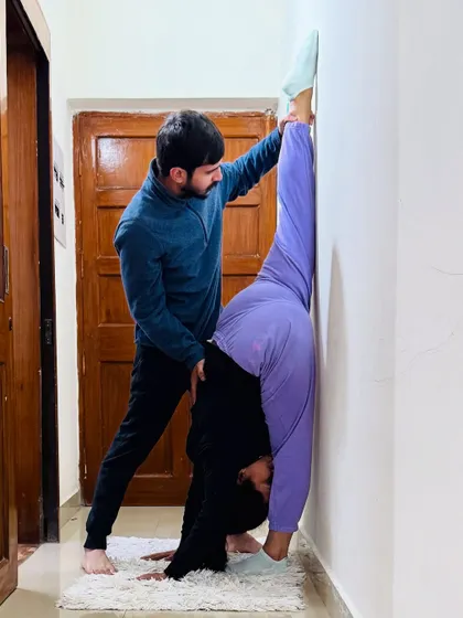 Using a wall is a great technique for deepening stretches like the Urdhva Prasarita Eka Padasana (Standing Split). I'm here to provide the gentle pressure needed to open the hamstrings safely.