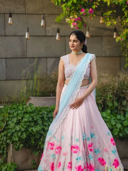 A full-length view of this dreamy lehenga. The makeup and simple ponytail hairstyle are designed to complement the outfit without competing with it.