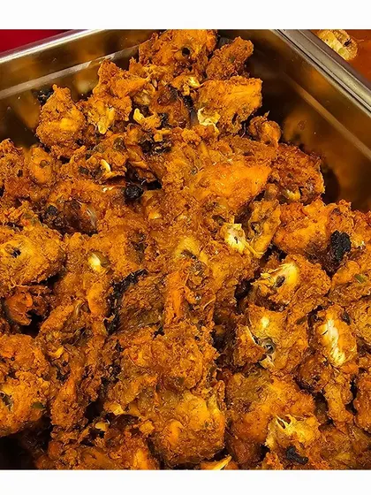 A tray of delicious fried chicken, a popular choice for non-vegetarian guests at our catered events.
