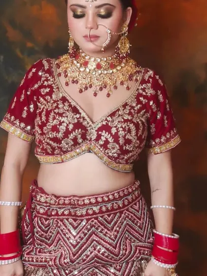 This bride is wearing a custom Polki choker with red bead drops, designed to match her red embroidered lehenga.