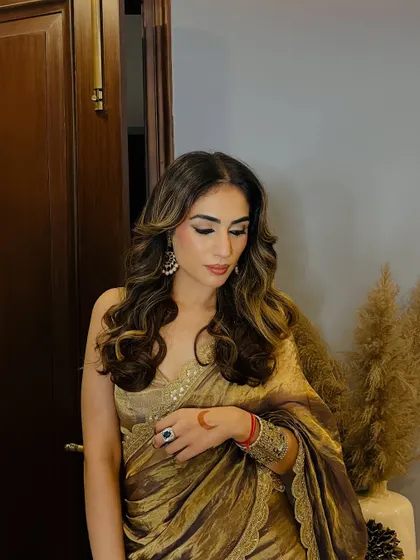 A candid moment in my gold saree, showing how the fabric moves and drapes. It’s all about feeling comfortable and confident in what you wear.