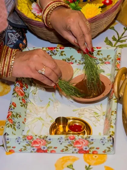 The preparation of a traditional puja thali for a pre-wedding ceremony. We believe in capturing the small cultural details that are integral to the celebration.