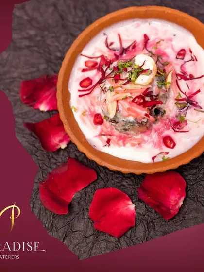 Blending love in every dish. A beautiful rose-flavored dessert served in a clay pot and garnished with fresh rose petals and pomegranate seeds.