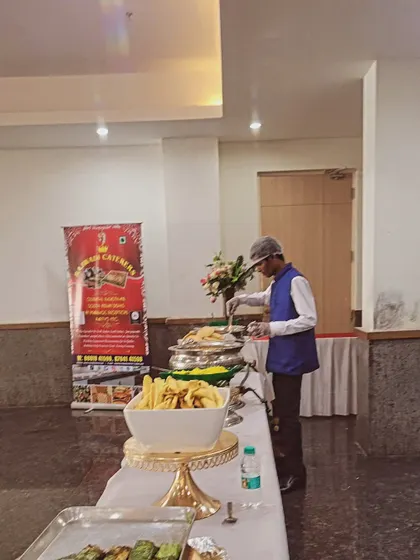 A member of my staff attending to the buffet line. You can see my company banner in the background, assuring you of our professional presence at your event.