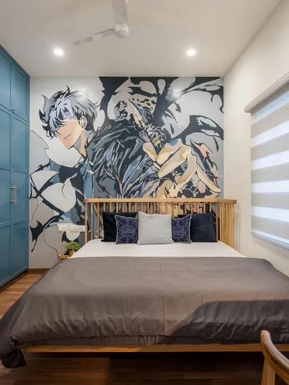 For a young anime fan, we designed this bedroom featuring a large, custom wall mural of their favorite character. The artwork becomes the focal point, creating a dynamic and personalized space.