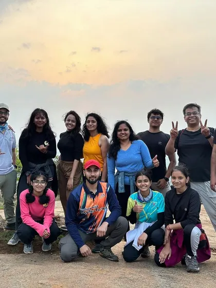 A happy group of trekkers and guides enjoying the view from the top.
