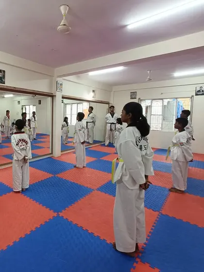 Students stand at attention, waiting for the next command.