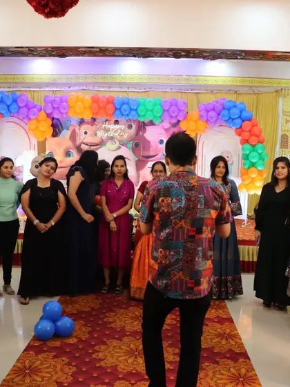 Getting a group of ladies ready for a fun balloon game at a family birthday party.