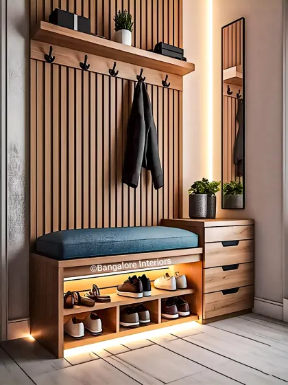 This hall tree unit is a complete entryway solution. It includes a bench with backlit shoe storage, coat hooks against a fluted wood panel, and a set of drawers for keys and mail.