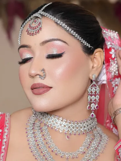 A close-up of the shimmery pink eye makeup and perfectly blended skin.