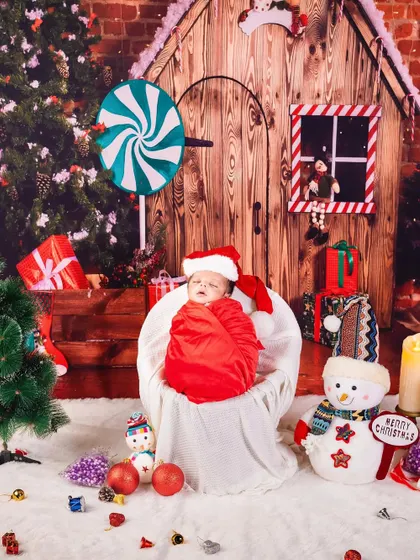 Our little Santa's helper is fast asleep. This festive Christmas-themed newborn shoot is a wonderful way to celebrate your baby's first holiday season.