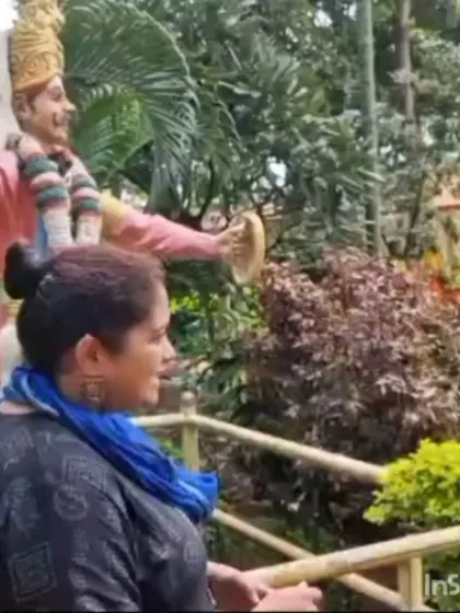 Explaining the significance of a folk art installation to students at Janapada Loka.