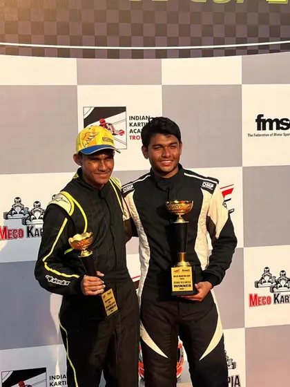 Two teammates celebrating their podium finishes together.