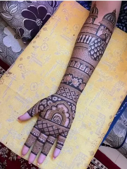 A single-arm view of a royal-themed bridal design, with palace architecture and a peacock.