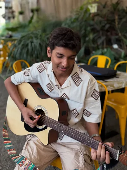 A young musician getting ready for his performance at our cafe. We love providing a platform for local talent to shine.