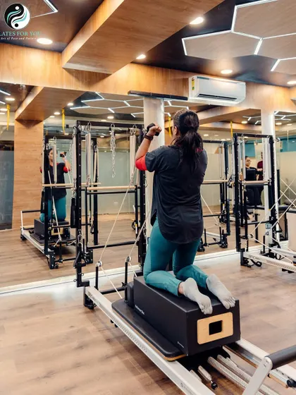 This kneeling exercise on the Reformer challenges core stability while working the arms and shoulders against the resistance of the springs.