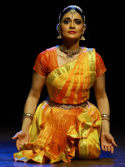 A seated pose of quiet contemplation from the "SARVASYA" performance.