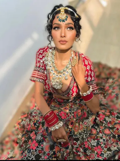 The sunlight beautifully highlights the details of this unique floral bridal lehenga.