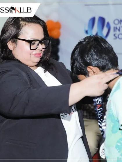 A young player is awarded his ChessKlub medal for his performance in the tournament. These moments of recognition are crucial for building confidence.