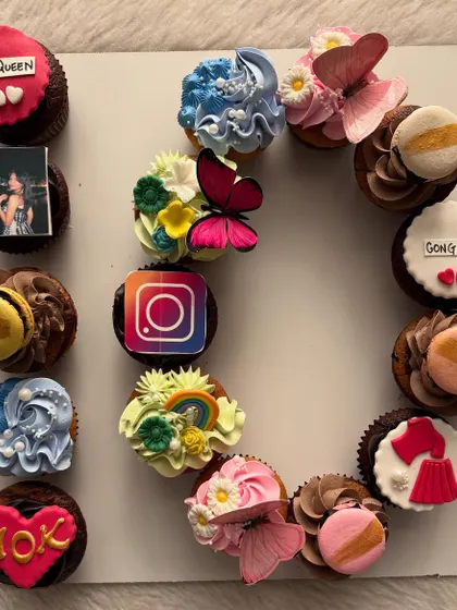 Another view of the 10k followers celebration set, showing the variety of custom toppers including macarons, butterflies, and personalized messages like 'Insta Queen'.