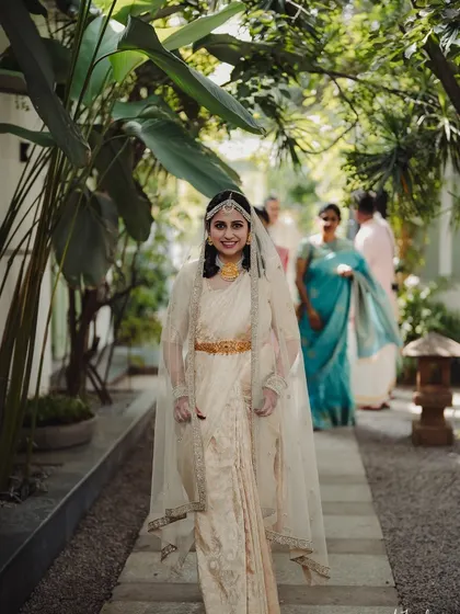 A beautiful bride walking down a stone pathway towards her wedding ceremony, embodying grace and anticipation. I ensure every entrance is as memorable as the vows themselves.