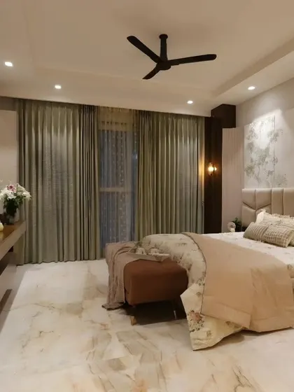 This shot captures the overall layout of the master bedroom, from the bed to the TV unit, showcasing a design where luxury is about lasting comfort.