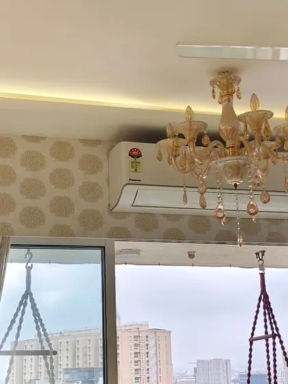 This image shows my skill in working around obstacles. The wallpaper pattern is perfectly continuous above and below the air conditioning unit, with no awkward cuts.